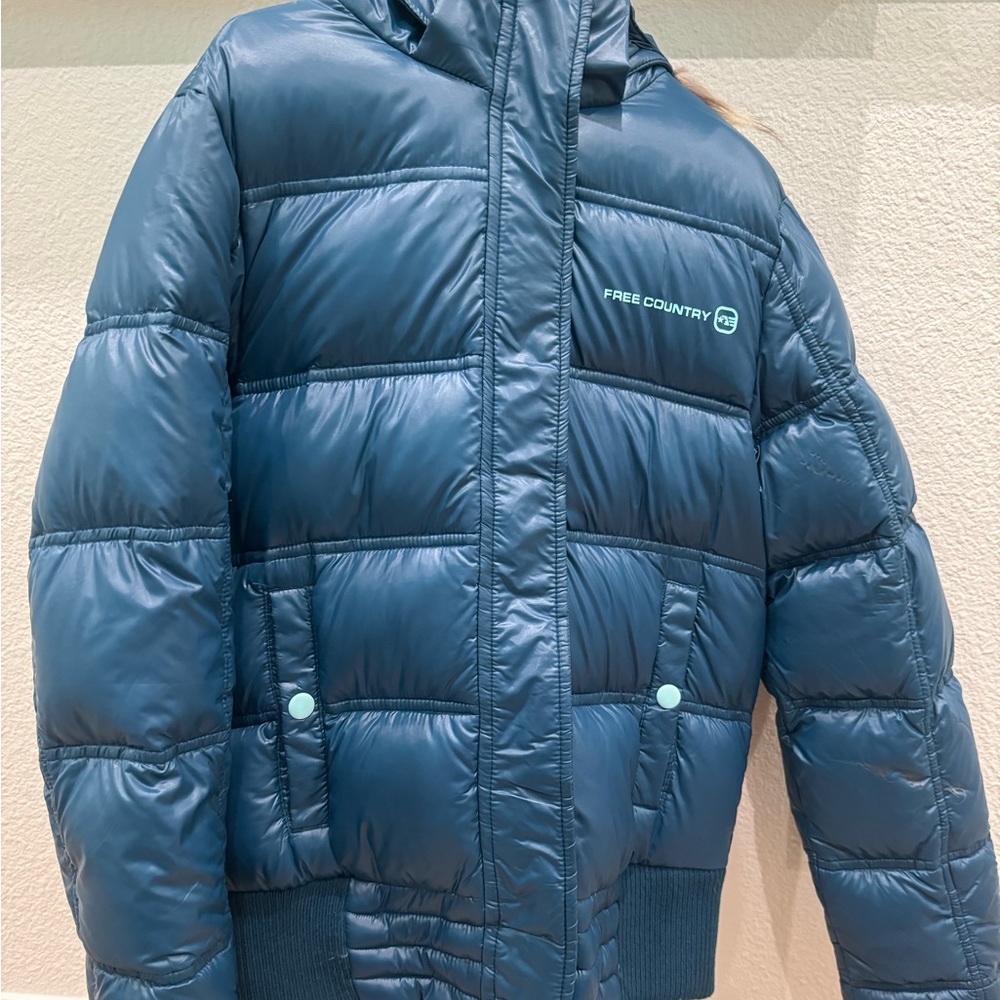 A kid’s girl puffer jacket. Does have a piece that is burnt but no hole.